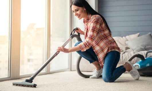 Vacuuming carpet | All Floors Design Centre