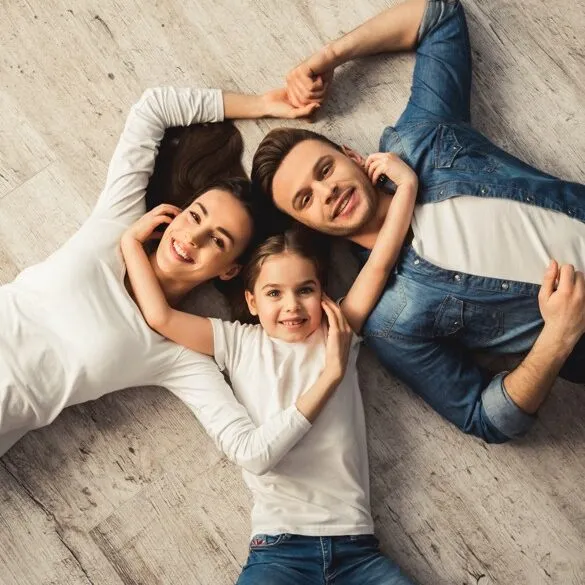 Happy family laying on floor | All Floors Design Centre